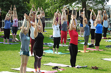 People doing yoga outside